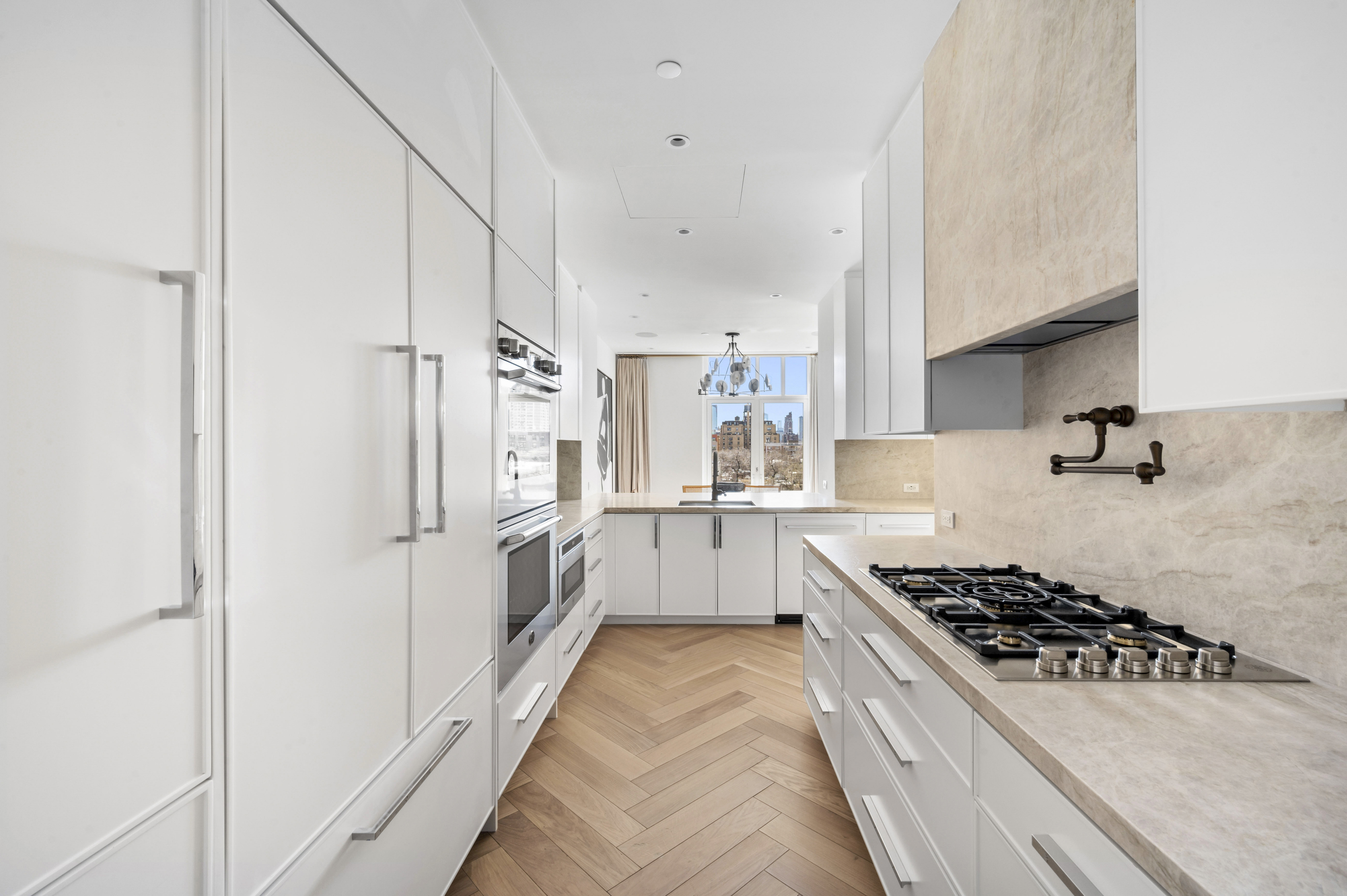 15 West 96th Street, Unit 10 Manhattan, NY 10025 - Photo 2 of 20 a kitchen with stainless steel appliances a stove a sink and white cabinets