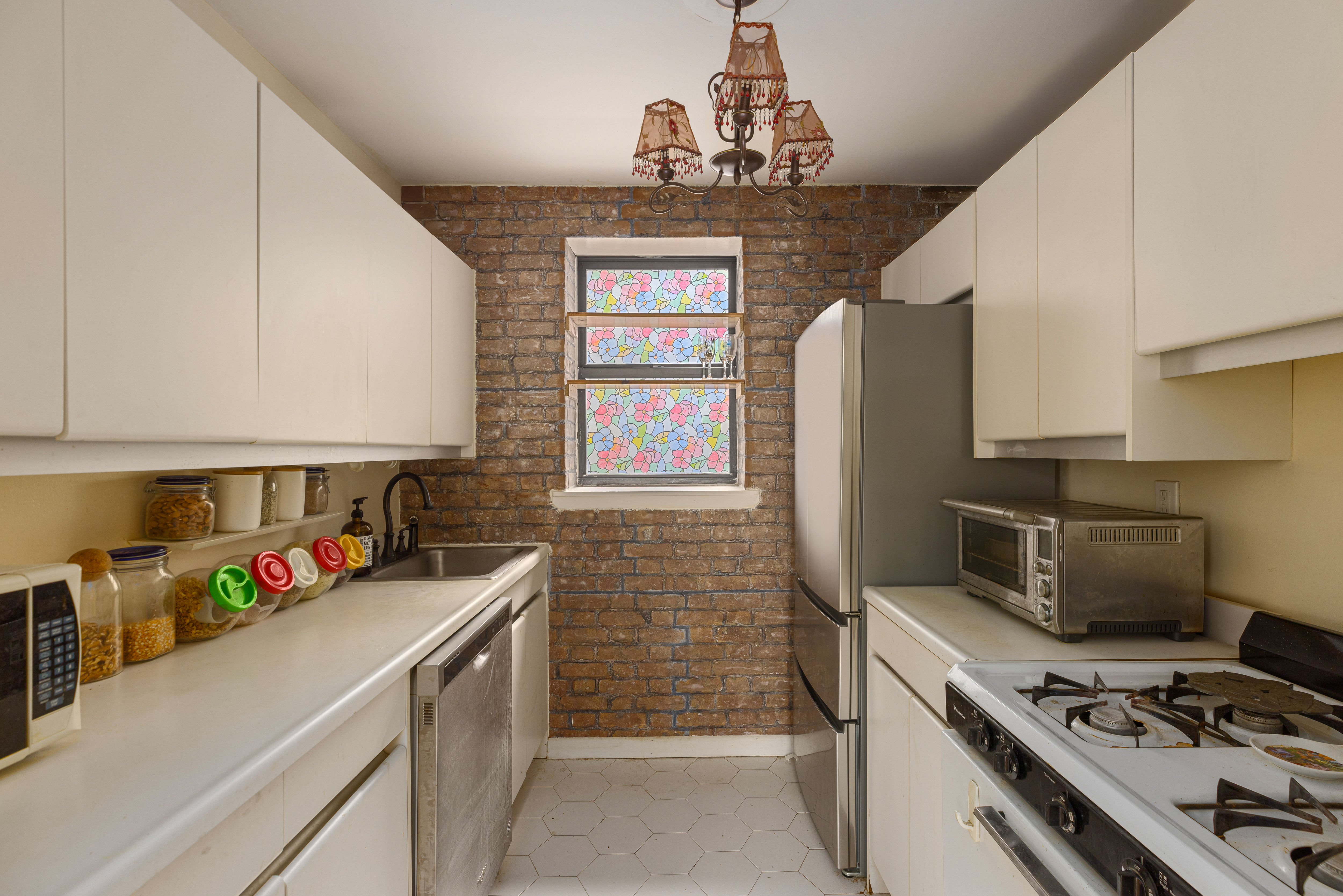 319 East 105th Street, Unit 2F Manhattan, NY 10029 - Photo 2 of 5 a kitchen with a stove and a refrigerator