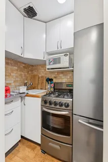 a kitchen with a stove and white cabinets