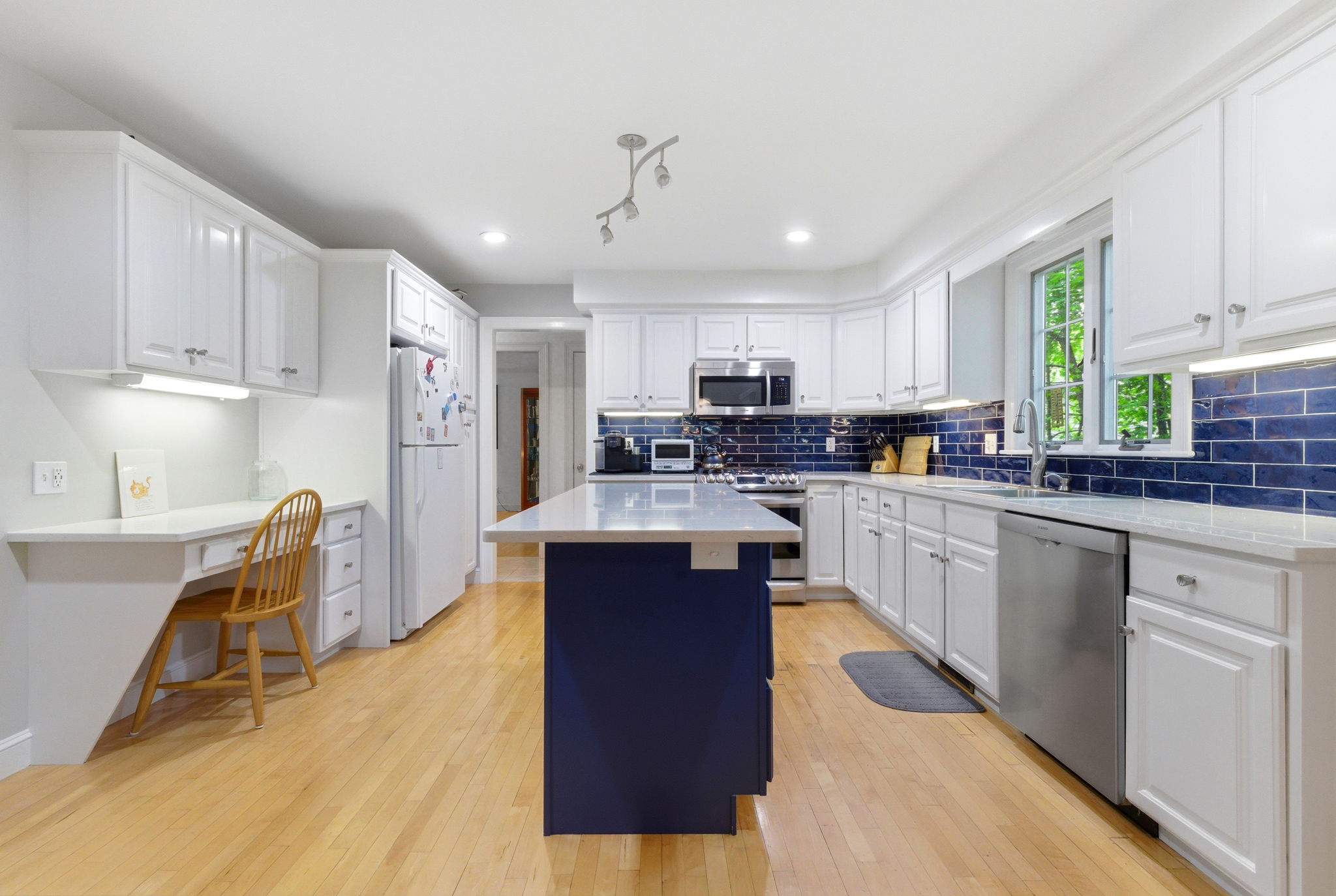 2 Laurel Street Lexington, MA 02421 - Photo 13 of 46 a kitchen with stainless steel appliances granite countertop a refrigerator a sink dishwasher a stove and white countertops with wooden floor