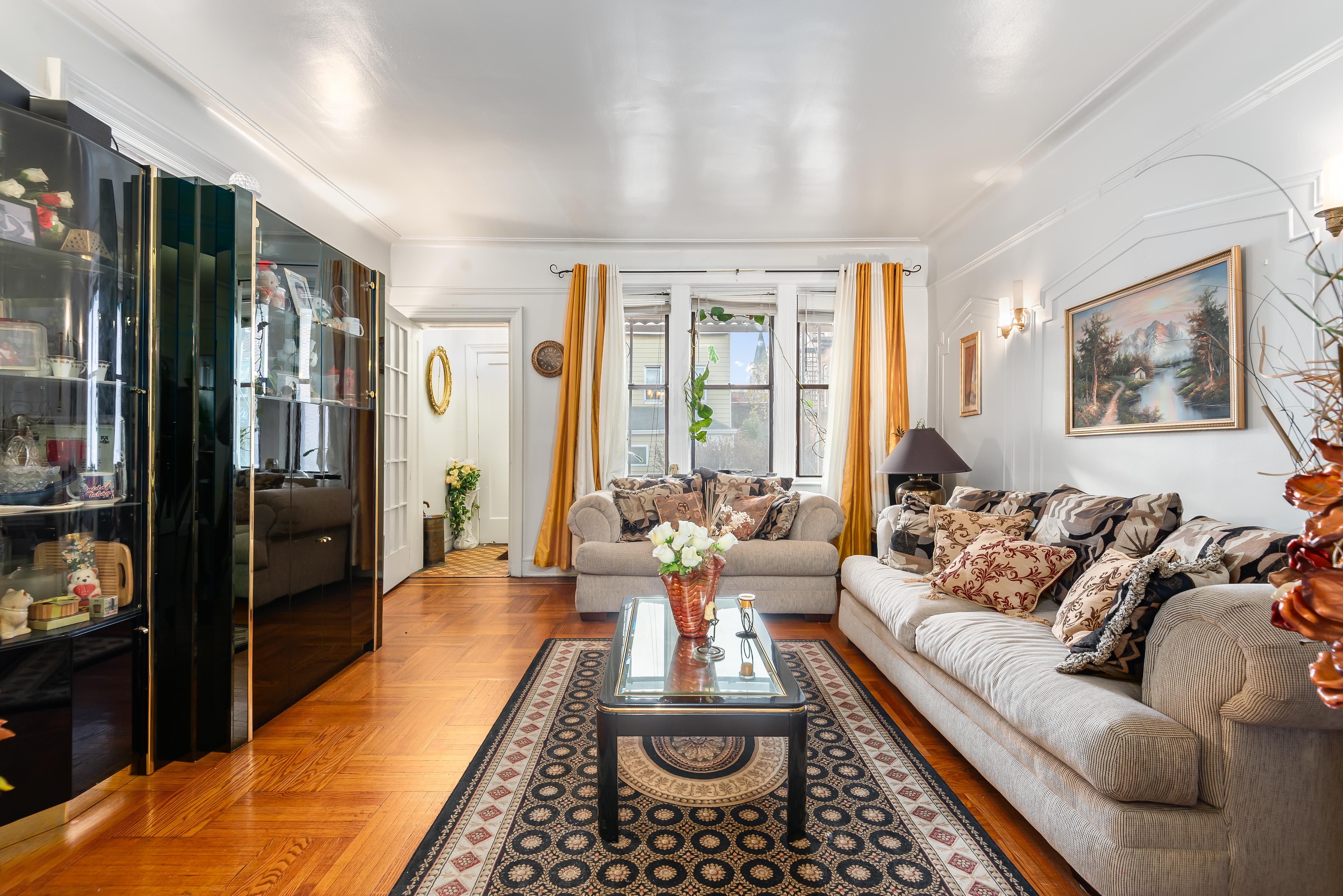 15 Lloyd Street Brooklyn, NY 11226 - Photo 2 of 18 a living room with furniture fireplace and large window