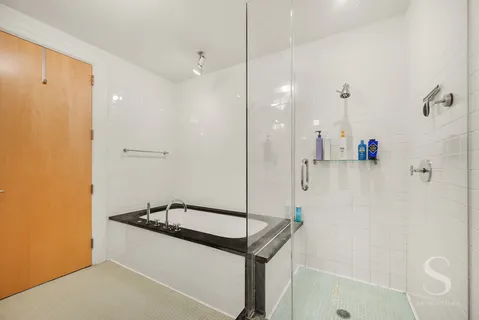 a bathroom with a sink a bath tub and shower