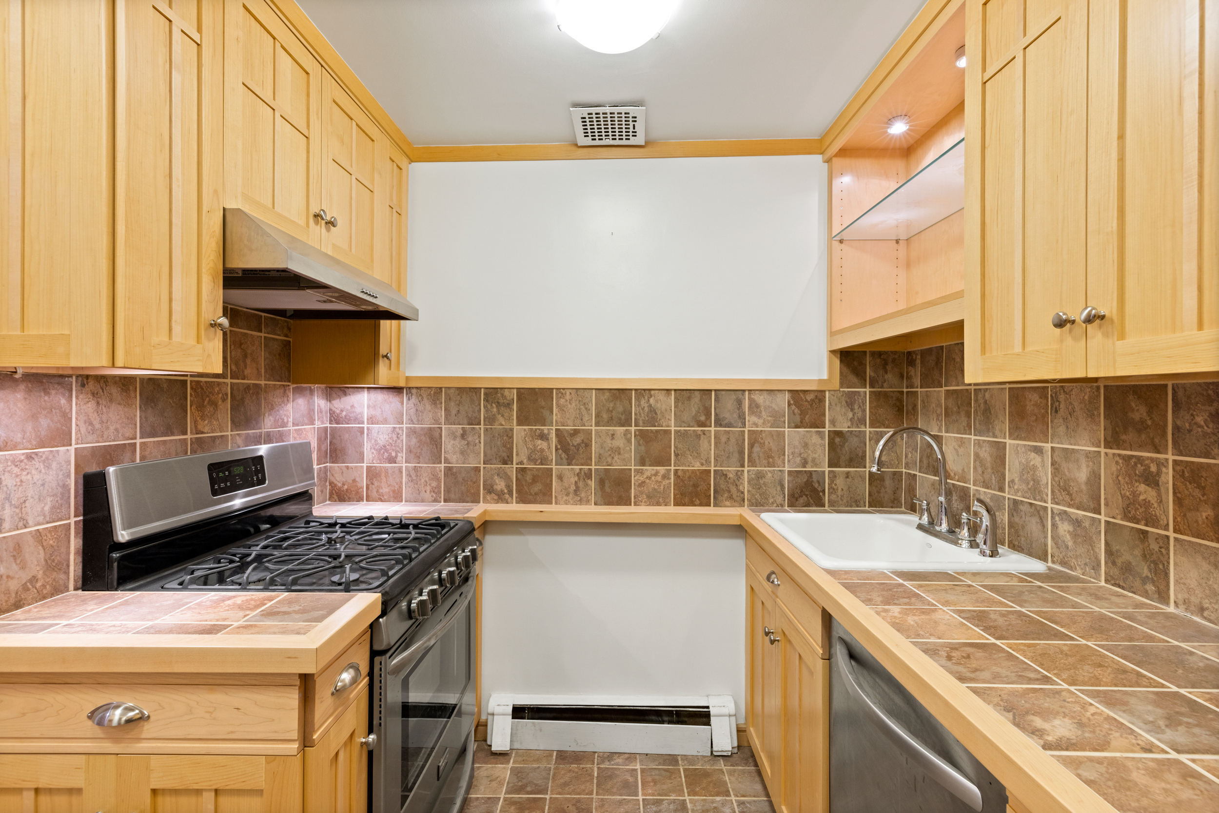 136 East 30th Street, Unit DUPLEX Manhattan, NY 10016 - Photo 16 of 26 a kitchen with a stove a sink and a microwave