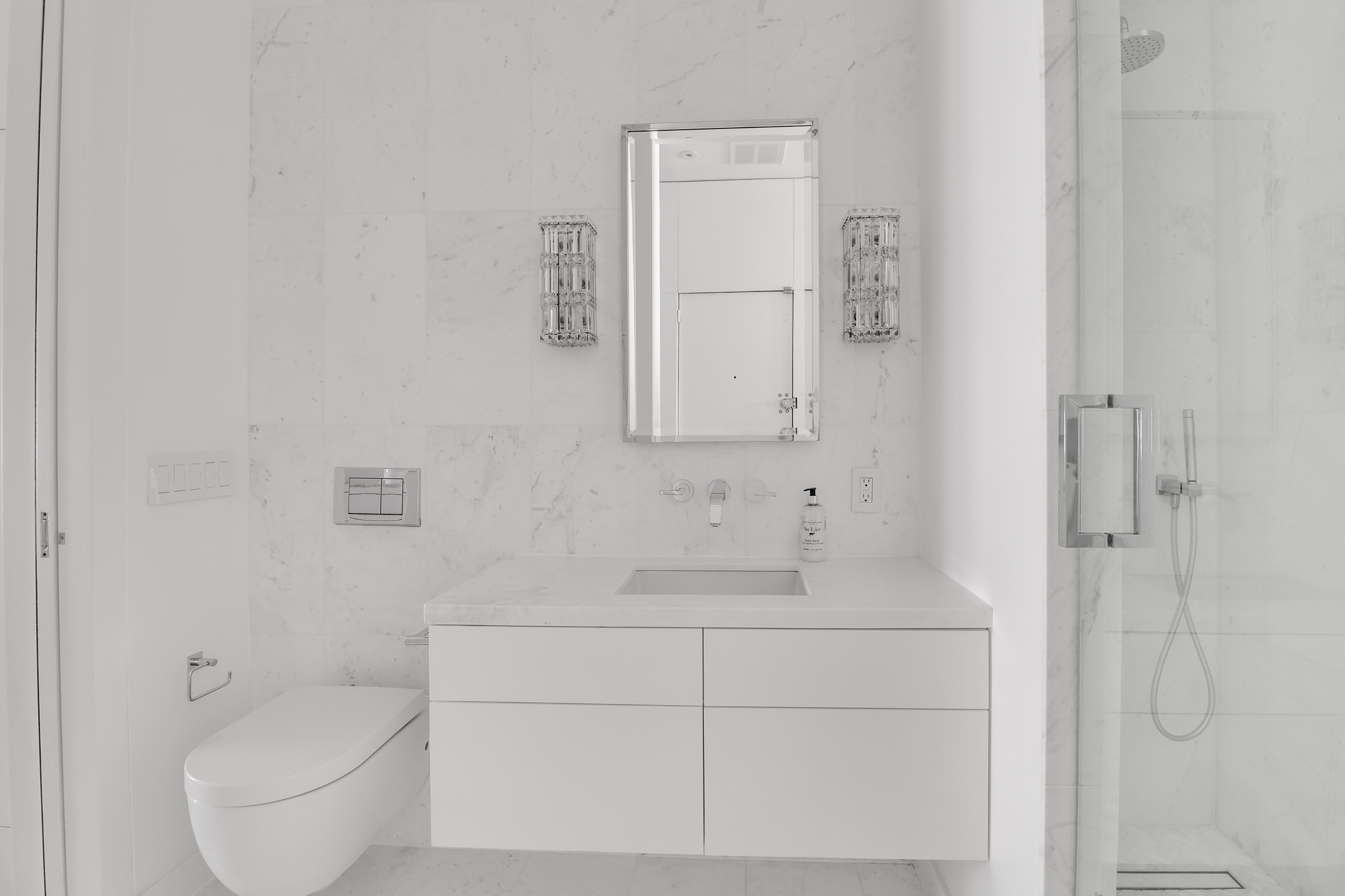 14 East 68th Street, Unit 3 Manhattan, NY 10065 - Photo 10 of 16 a bathroom with a toilet sink and shower