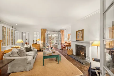 a living room with furniture large window and a fireplace