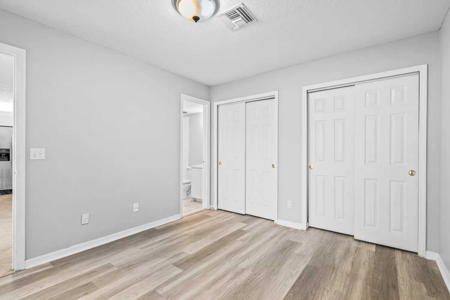 a view of an empty room and wooden floor