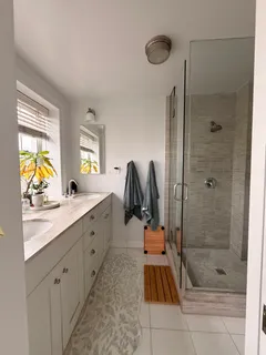 a bathroom with a granite countertop sink a toilet and shower
