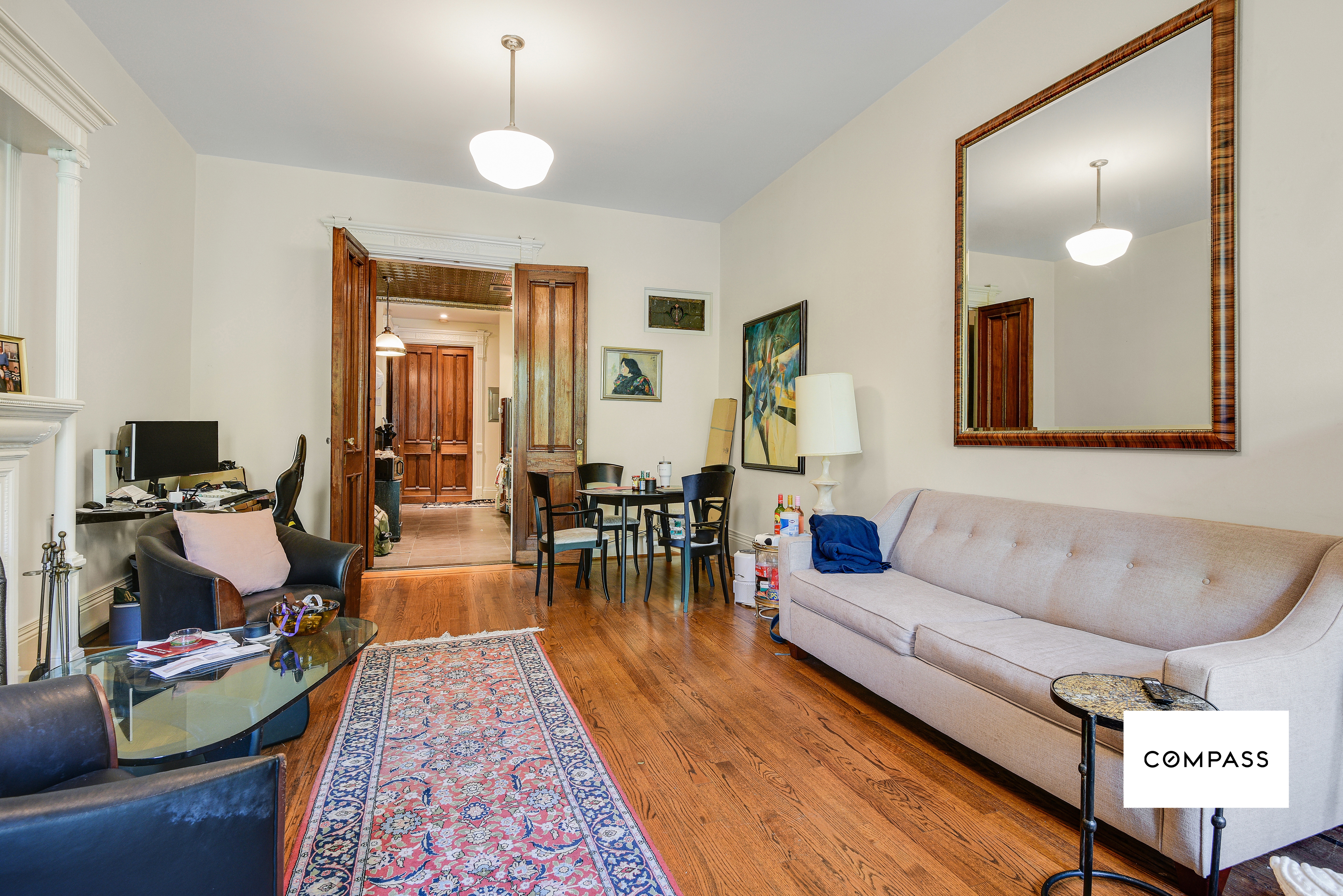 347 West 121st Street Manhattan, NY 10027 - Photo 3 of 10 a living room with furniture and wooden floor