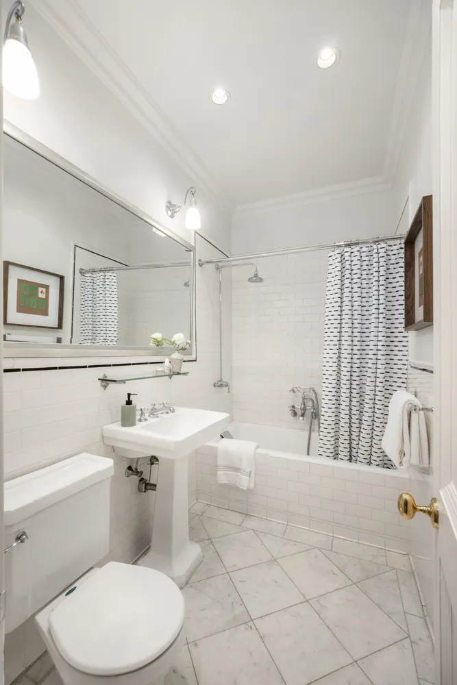 a bathroom with a sink a toilet and mirror