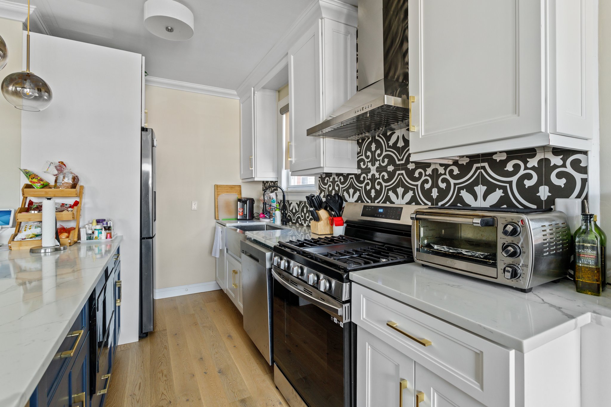 22-45 47th Street, Unit 3 Queens, NY 11105 - Photo 2 of 14 a kitchen with a stove and cabinets