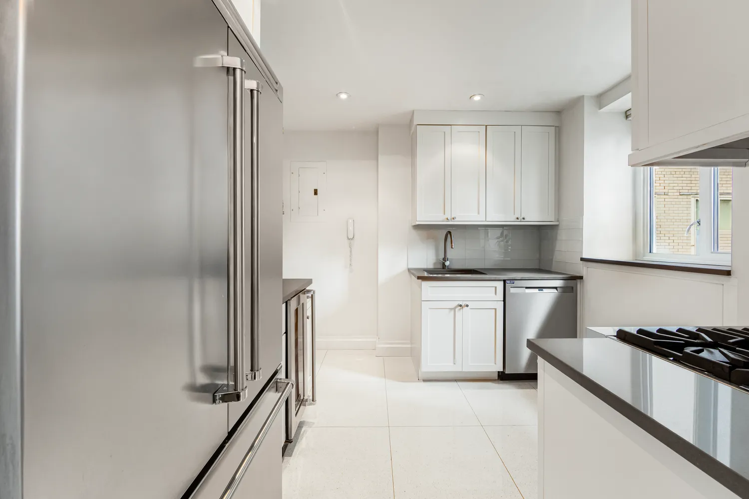 a kitchen with a refrigerator and a stove top oven