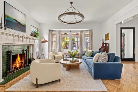 a living room with furniture a fireplace and a flat screen tv