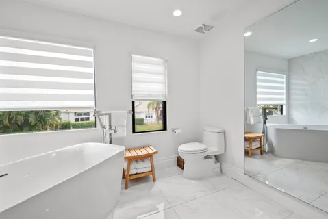 a very nice looking dining room with a large window and a fireplace