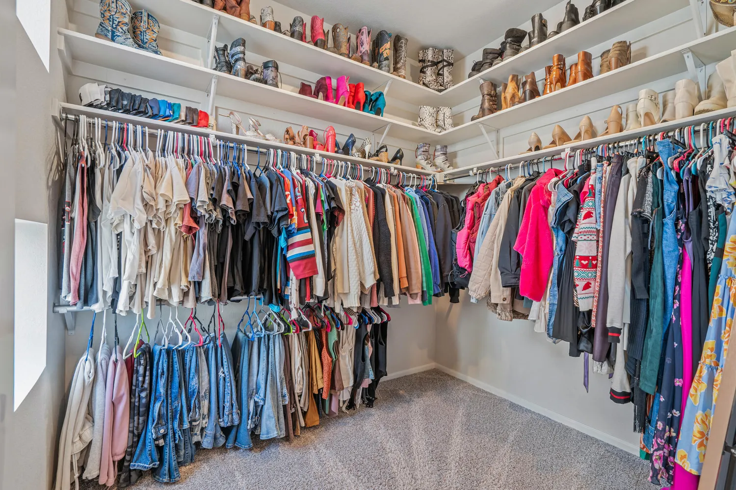 a view of walk in closet with clothes