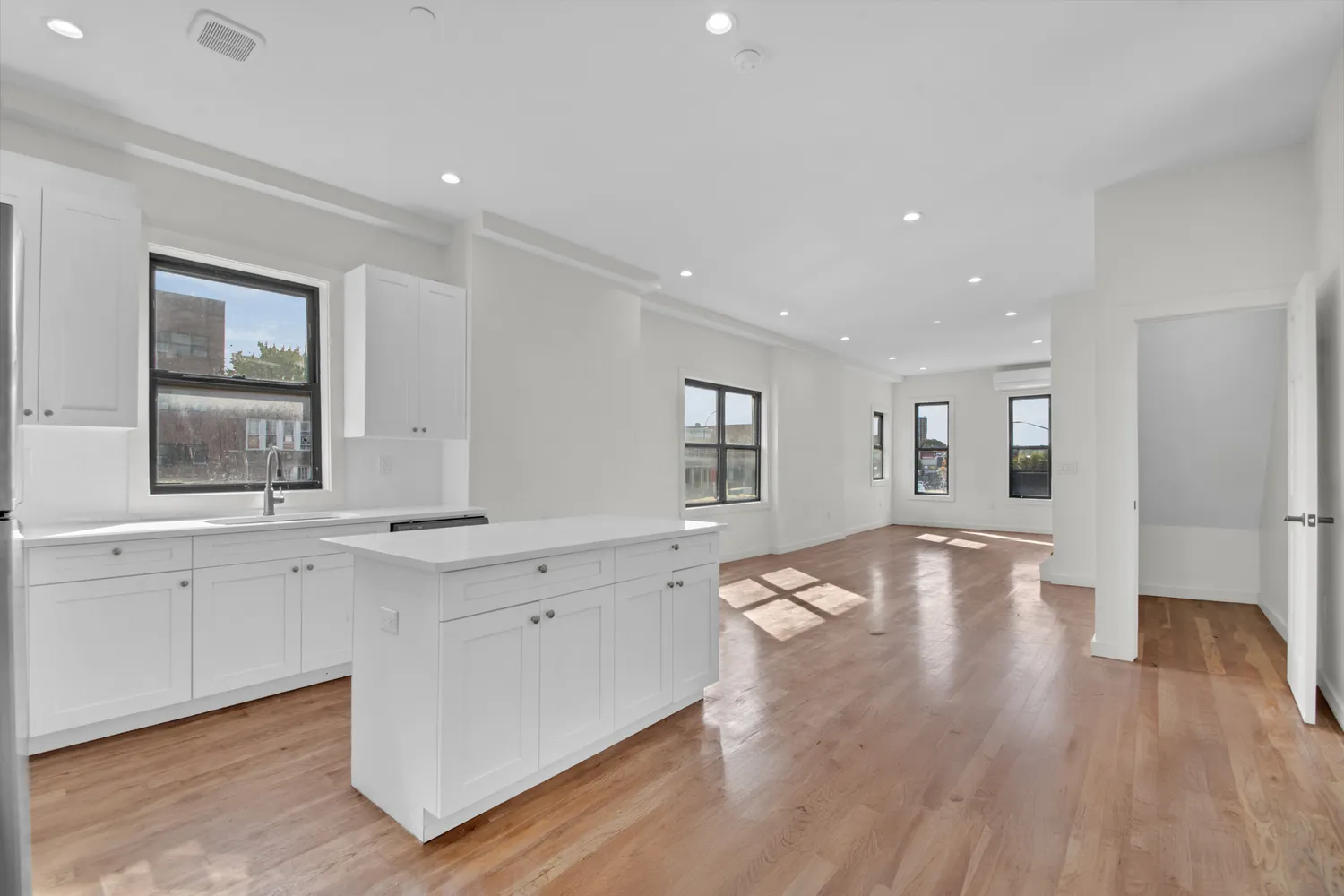 a view of a kitchen with wooden floor and a sink