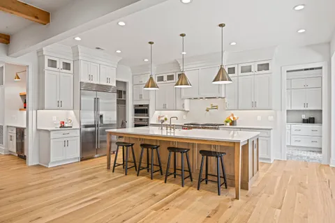 a kitchen with stainless steel appliances kitchen island granite countertop a sink and cabinets