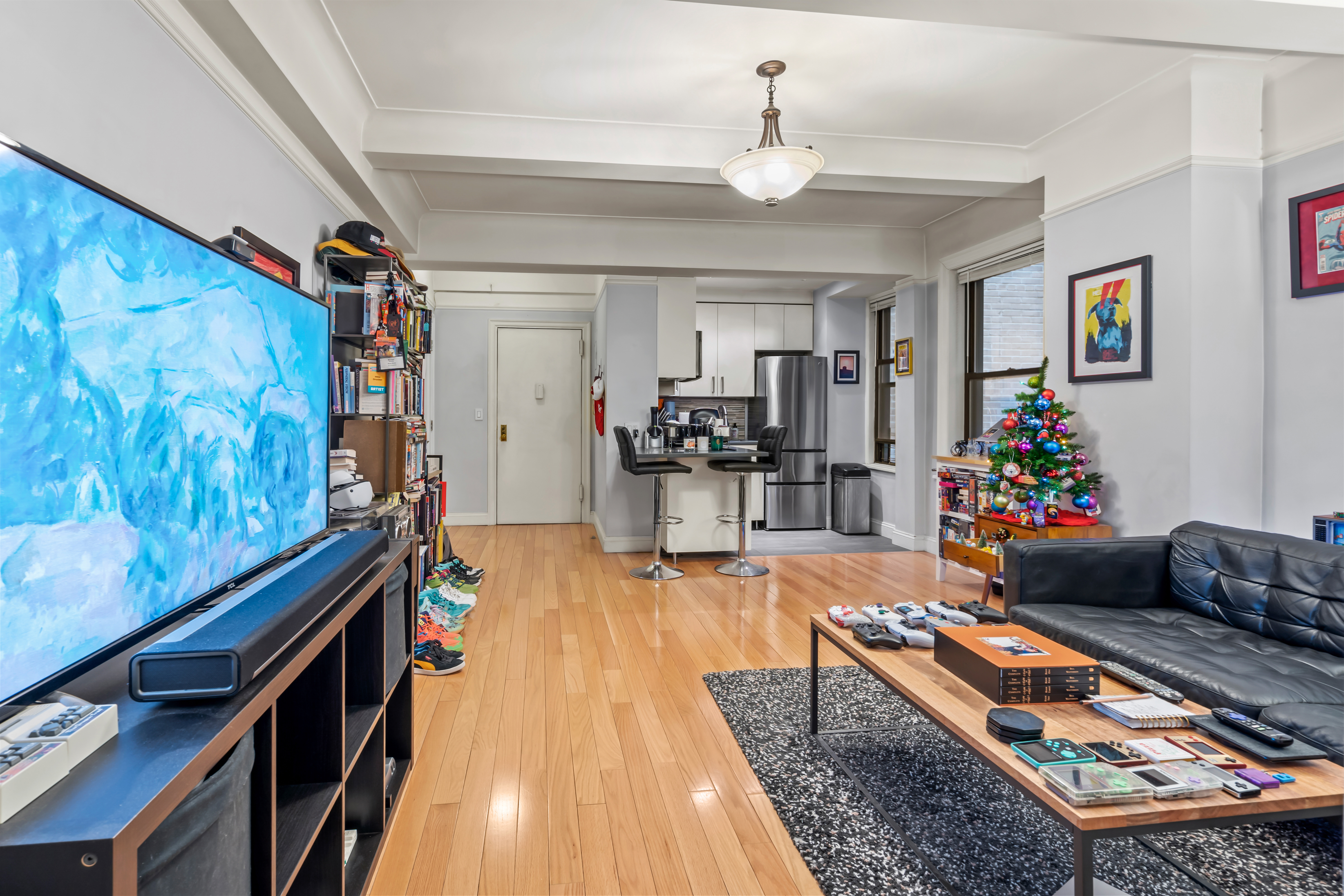 467 Central Park West, Unit 2G Manhattan, NY 10025 - Photo 3 of 10 a living room with furniture and a chandelier