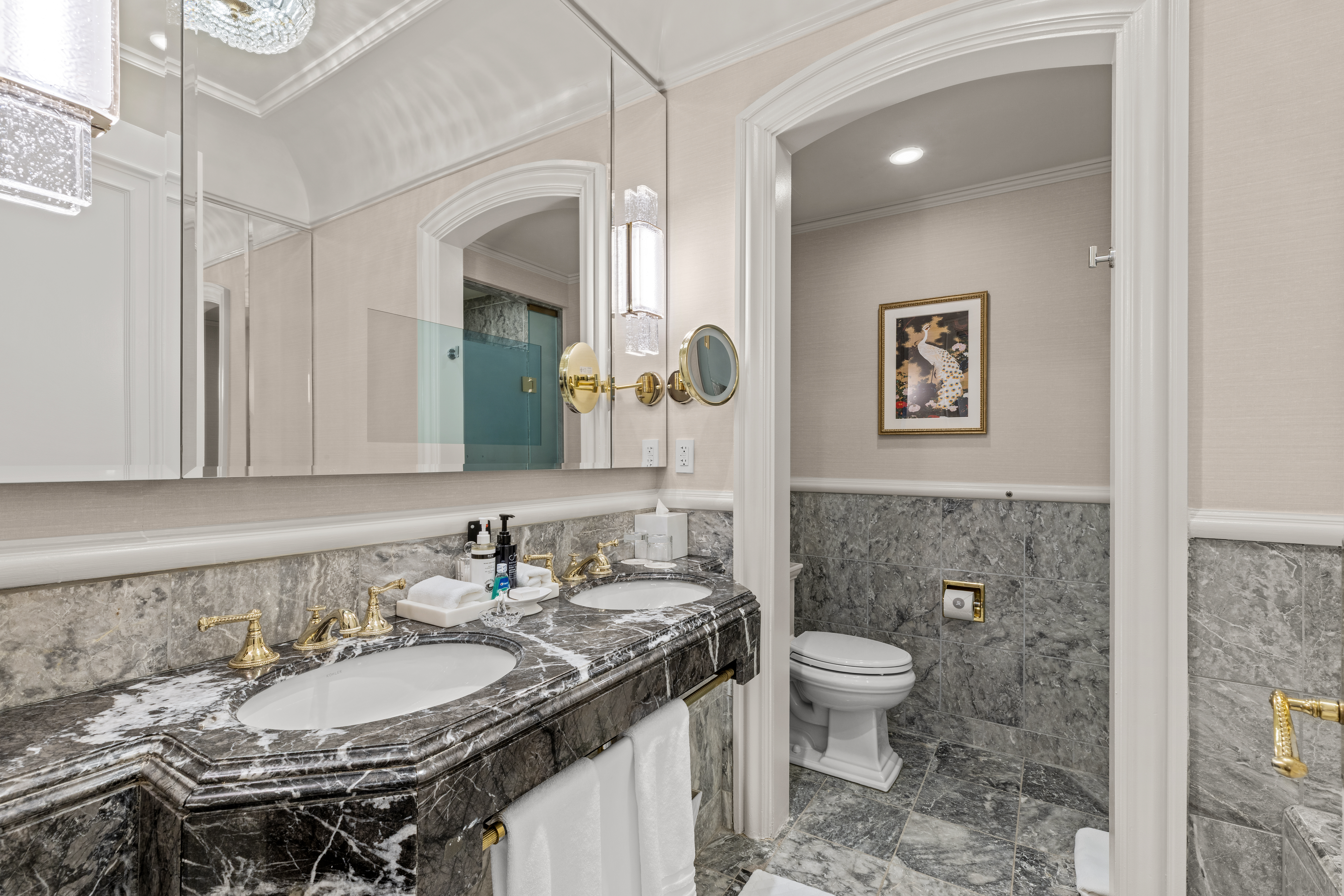 2 East 55th Street, Unit 918W17 Manhattan, NY 10022 - Photo 7 of 14 a bathroom with a granite countertop toilet a sink and a mirror