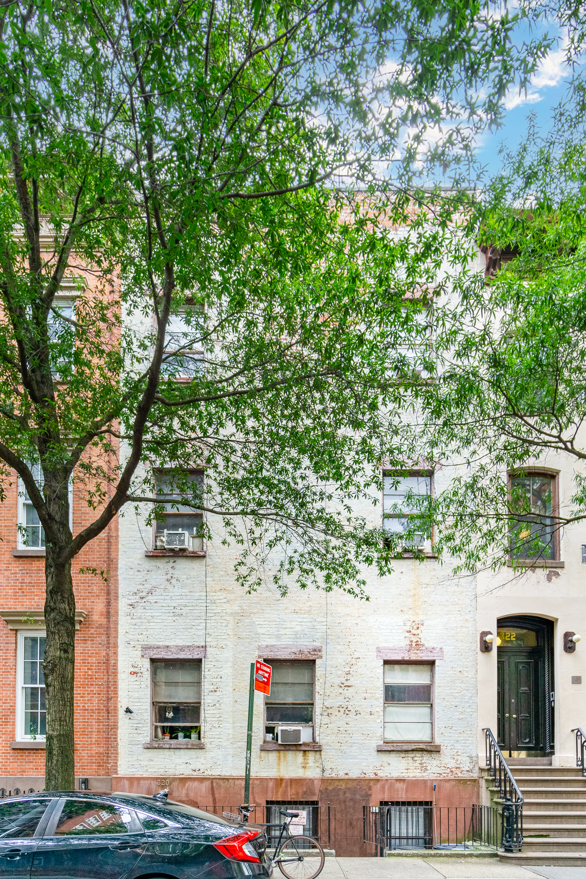 320 West 20th Street, Unit 14 Manhattan, NY 10011 - Photo 6 of 13 a front view of a multi story residential apartment building with yard