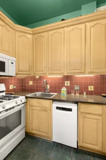 a kitchen with white cabinets and white appliances