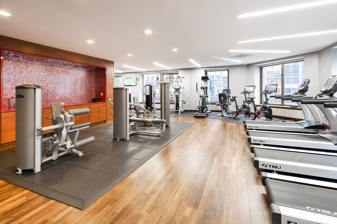 75 Wall Street, Unit 36F Manhattan, NY 10005 - Photo 13 of 15 a view of a room with gym equipment