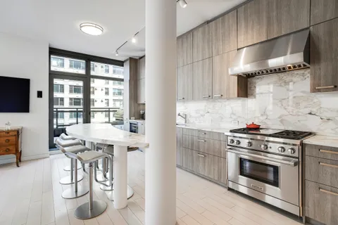 a kitchen with stainless steel appliances granite countertop a stove and a refrigerator