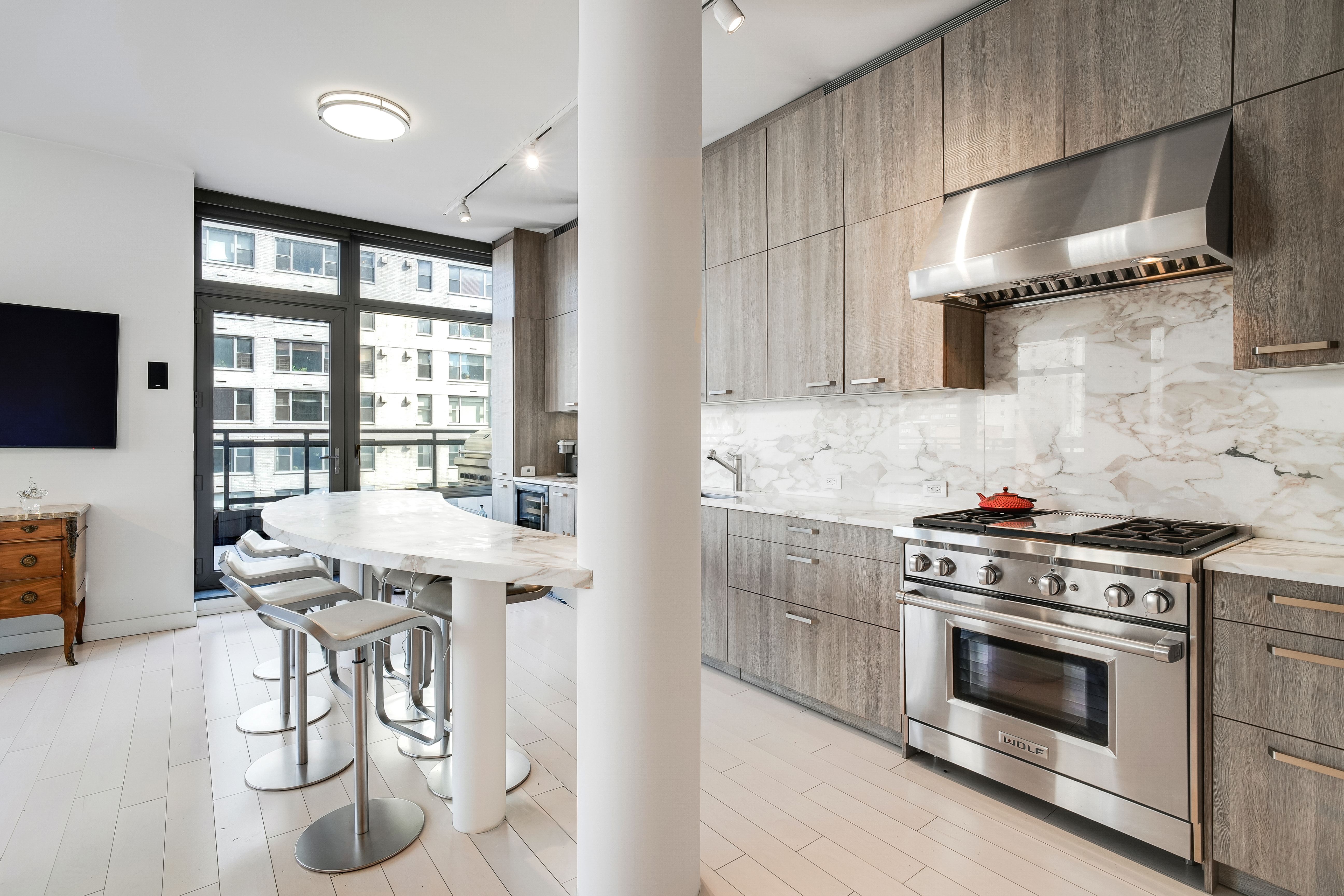 450 East 83rd Street, Unit 6B Manhattan, NY 10028 - Photo 6 of 25 a kitchen with stainless steel appliances granite countertop a stove and a refrigerator