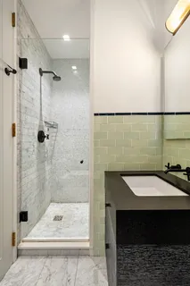 a bathroom with a sink a mirror and a shower