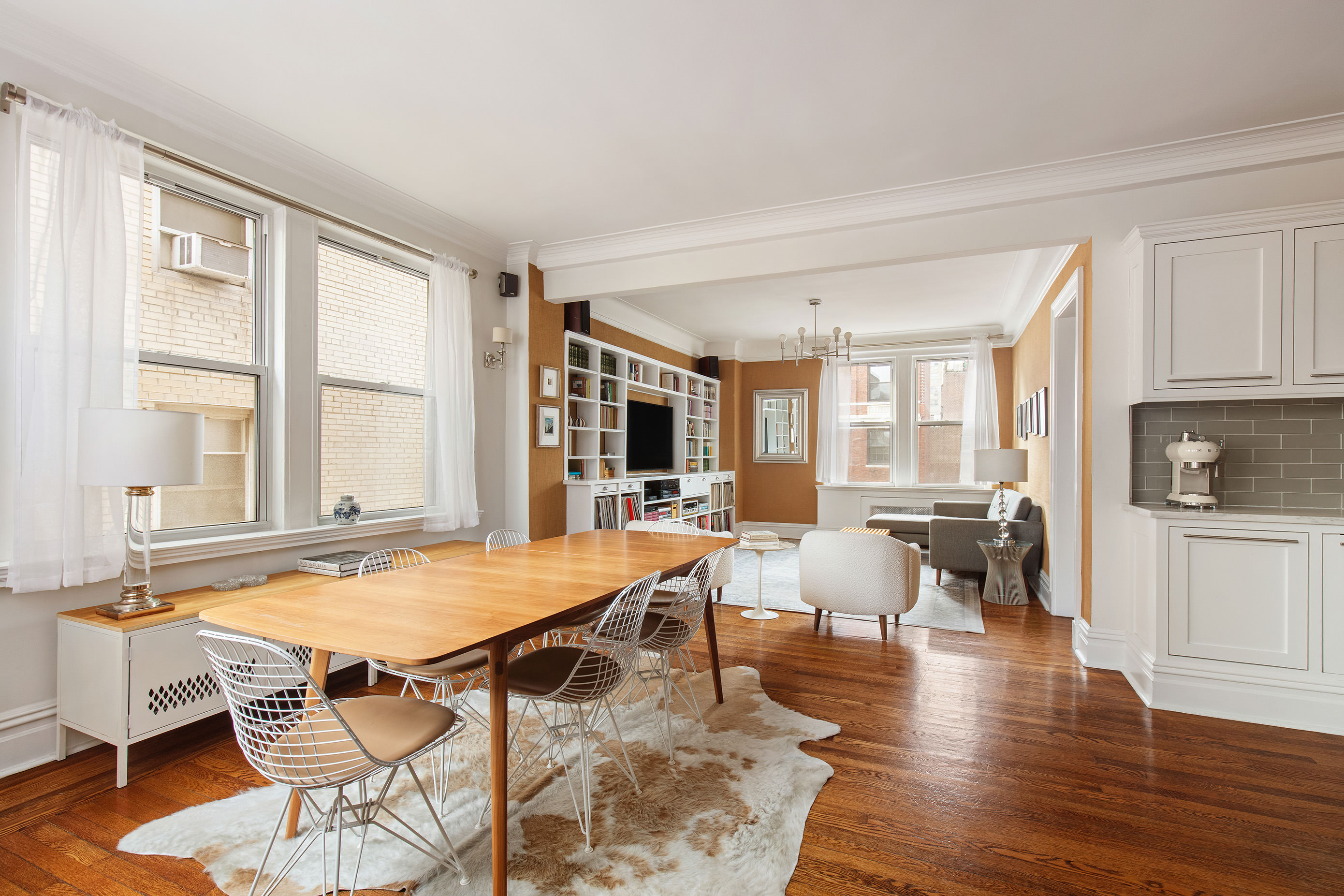 a view of a dining room with furniture window and wooden floor