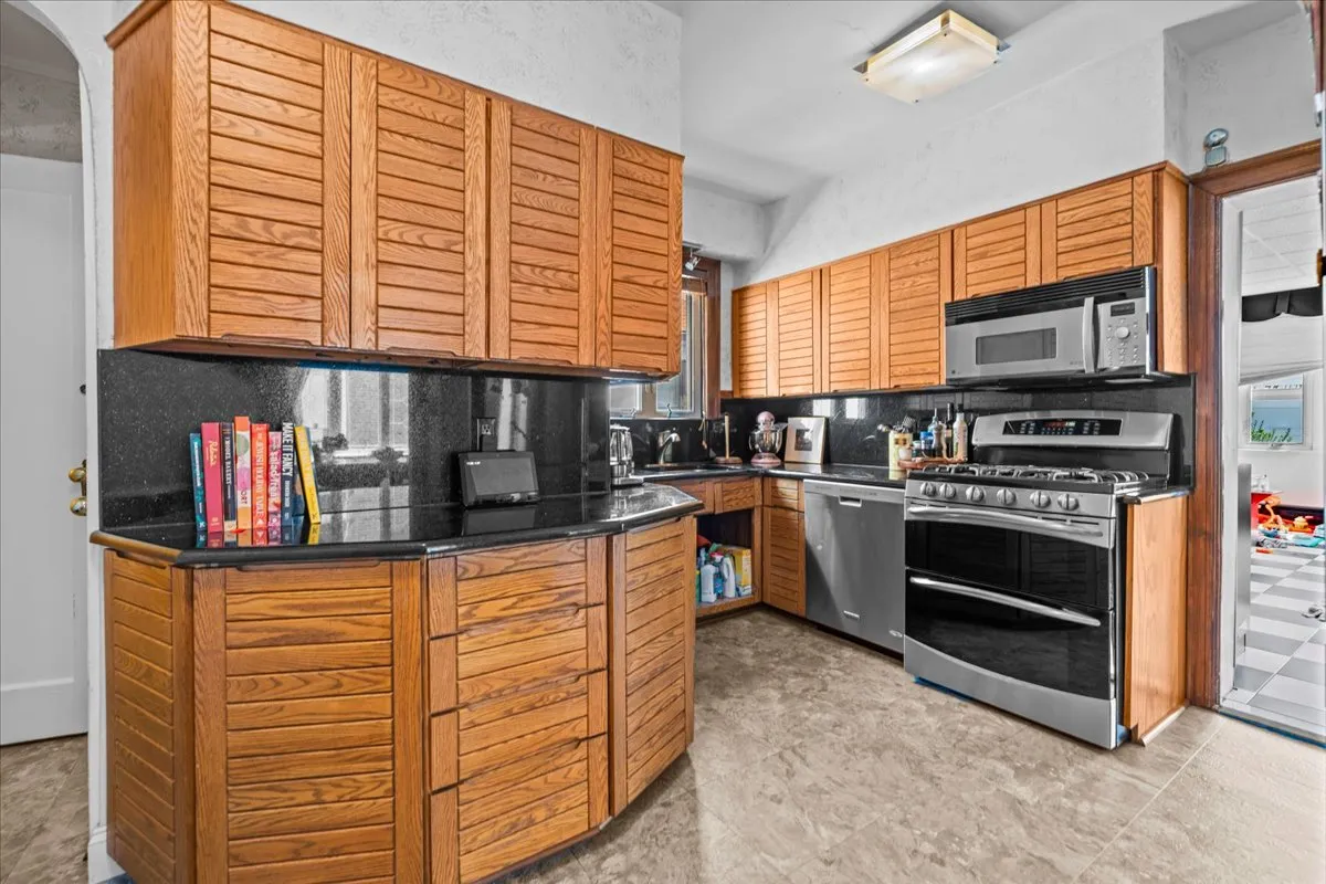 a kitchen with stainless steel appliances granite countertop a stove and a sink