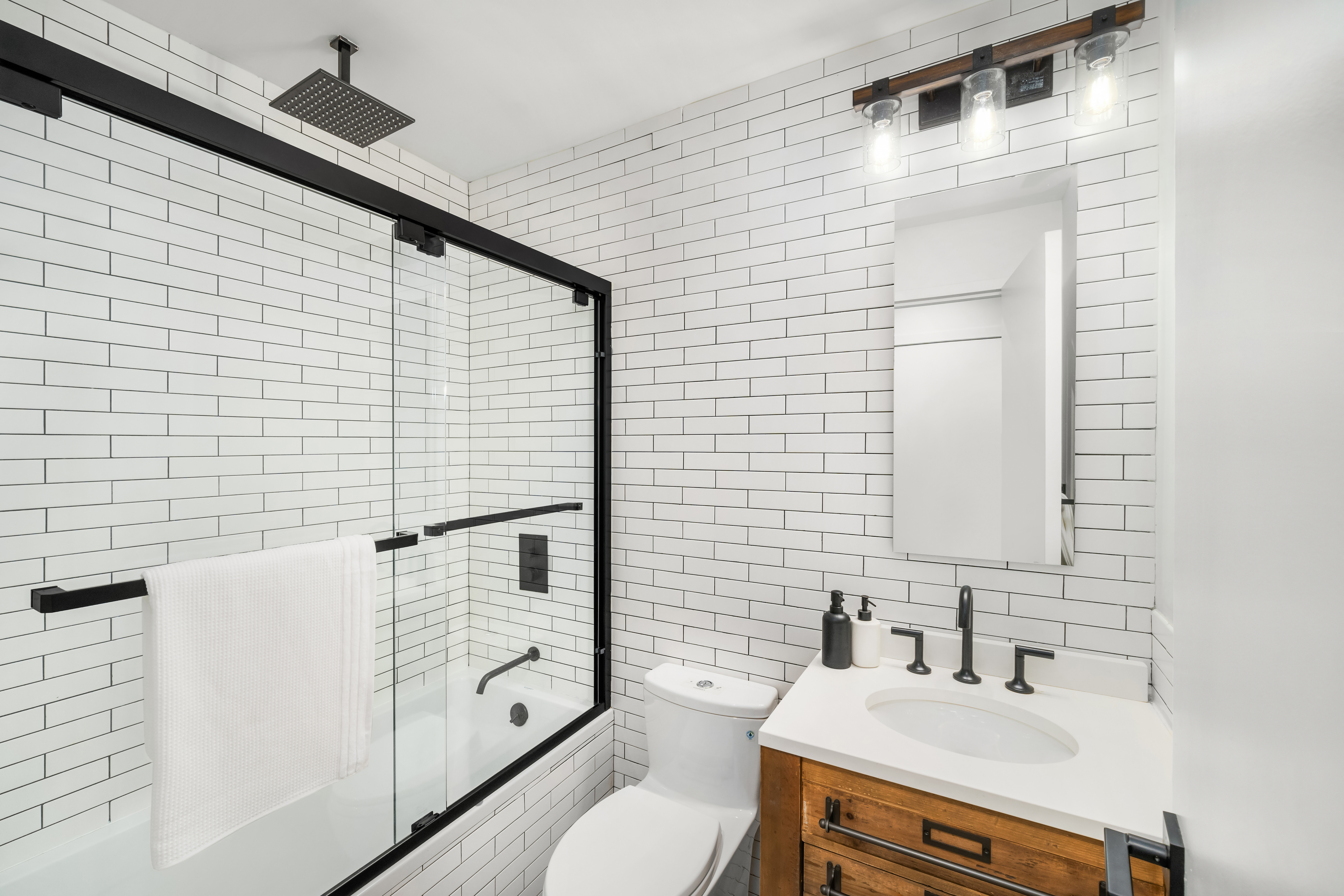 164 Bank Street, Unit 3A Manhattan, NY 10014 - Photo 7 of 8 a bathroom with a sink toilet and shower