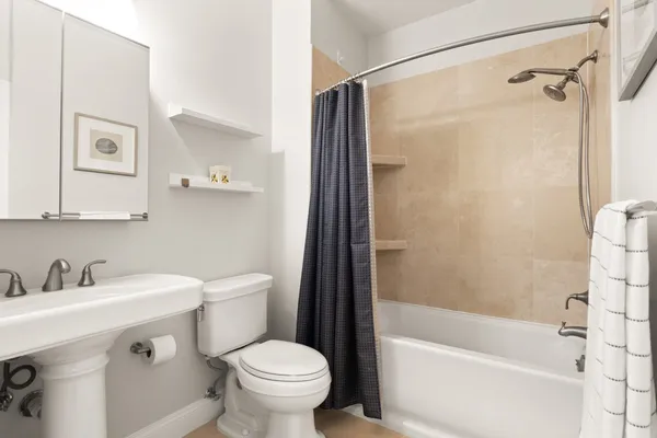 a bathroom with a sink toilet and shower