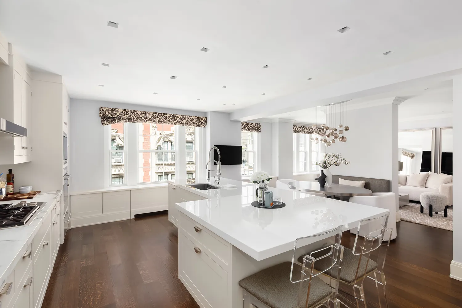 a large white kitchen with a table and chairs