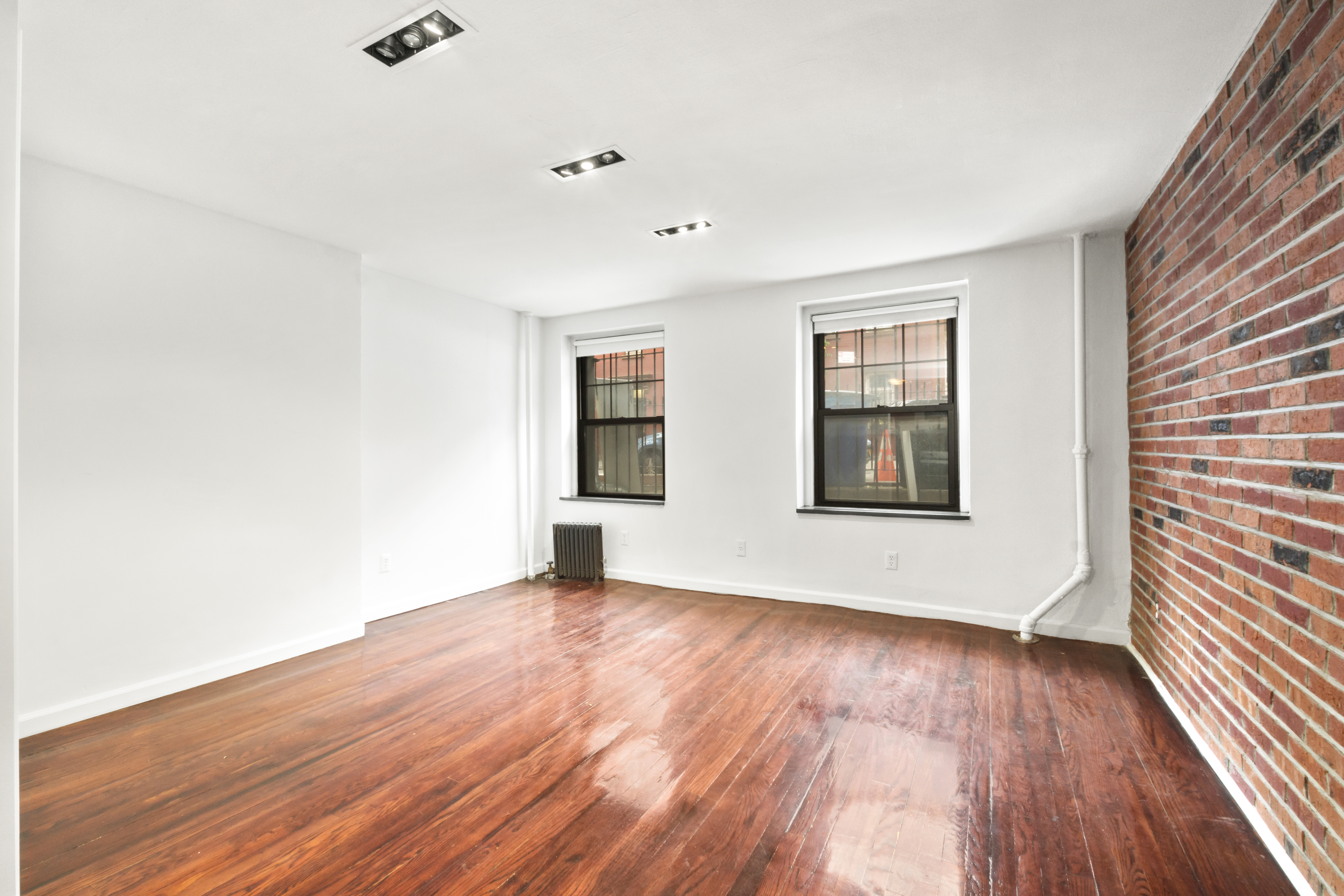 54 Jane Street Manhattan, NY 10014 - Photo 23 of 26 wooden floor in an empty room with a window