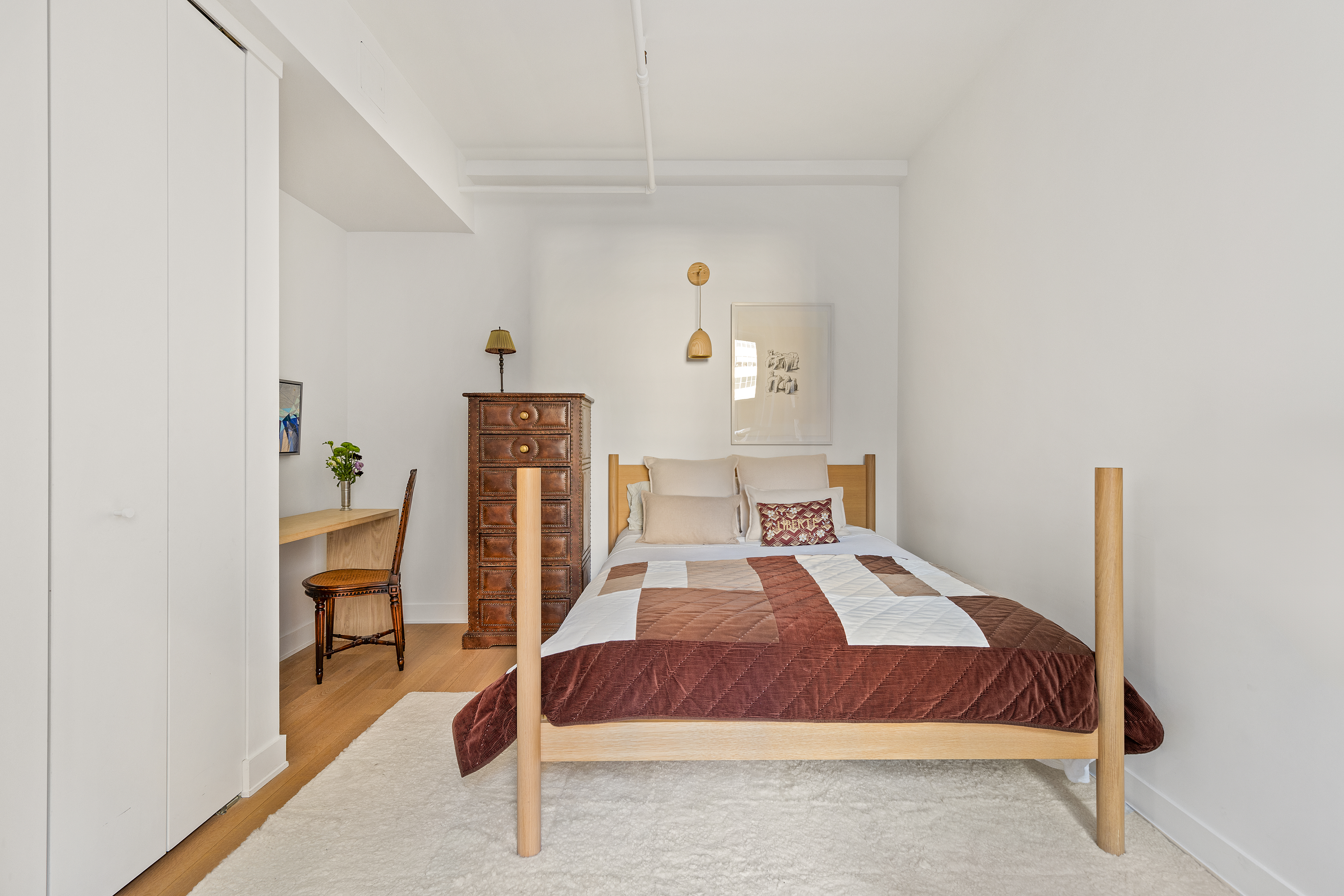 40 East 19th Street, Unit 7 Manhattan, NY 10003 - Photo 10 of 15 a bedroom with a bed and a table in it