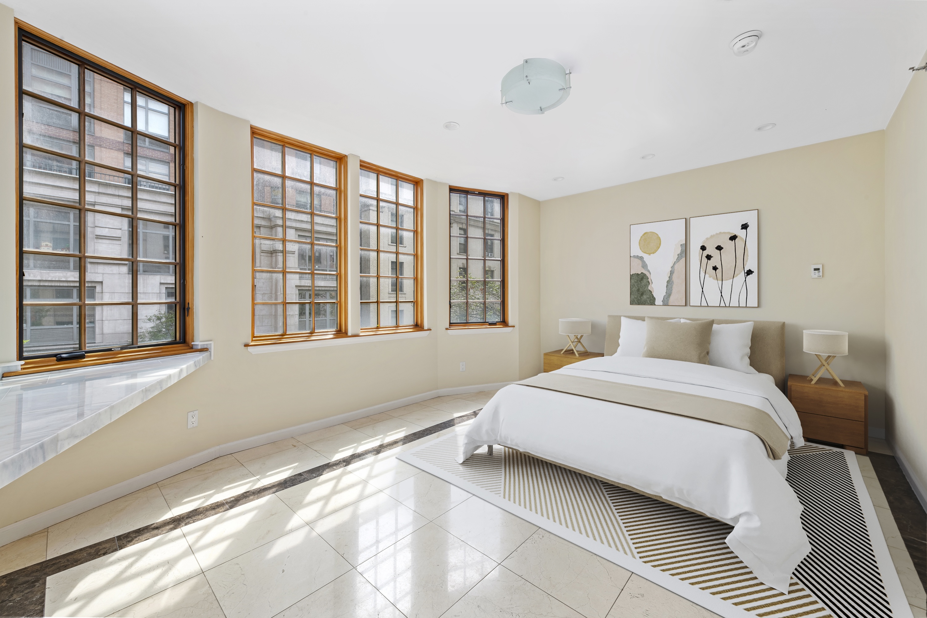 195 East 76th Street Manhattan, NY 10021 - Photo 16 of 20 a bedroom with a large bed and a large window