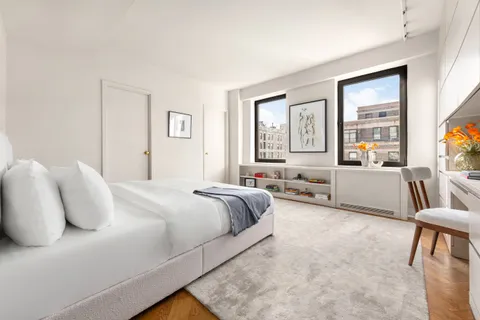 a bedroom with a large bed and a couch