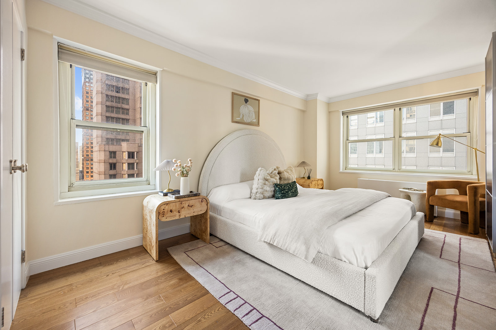 159 West 53rd Street, Unit 27H Manhattan, NY 10019 - Photo 6 of 15 a bedroom with a bed and wooden floor