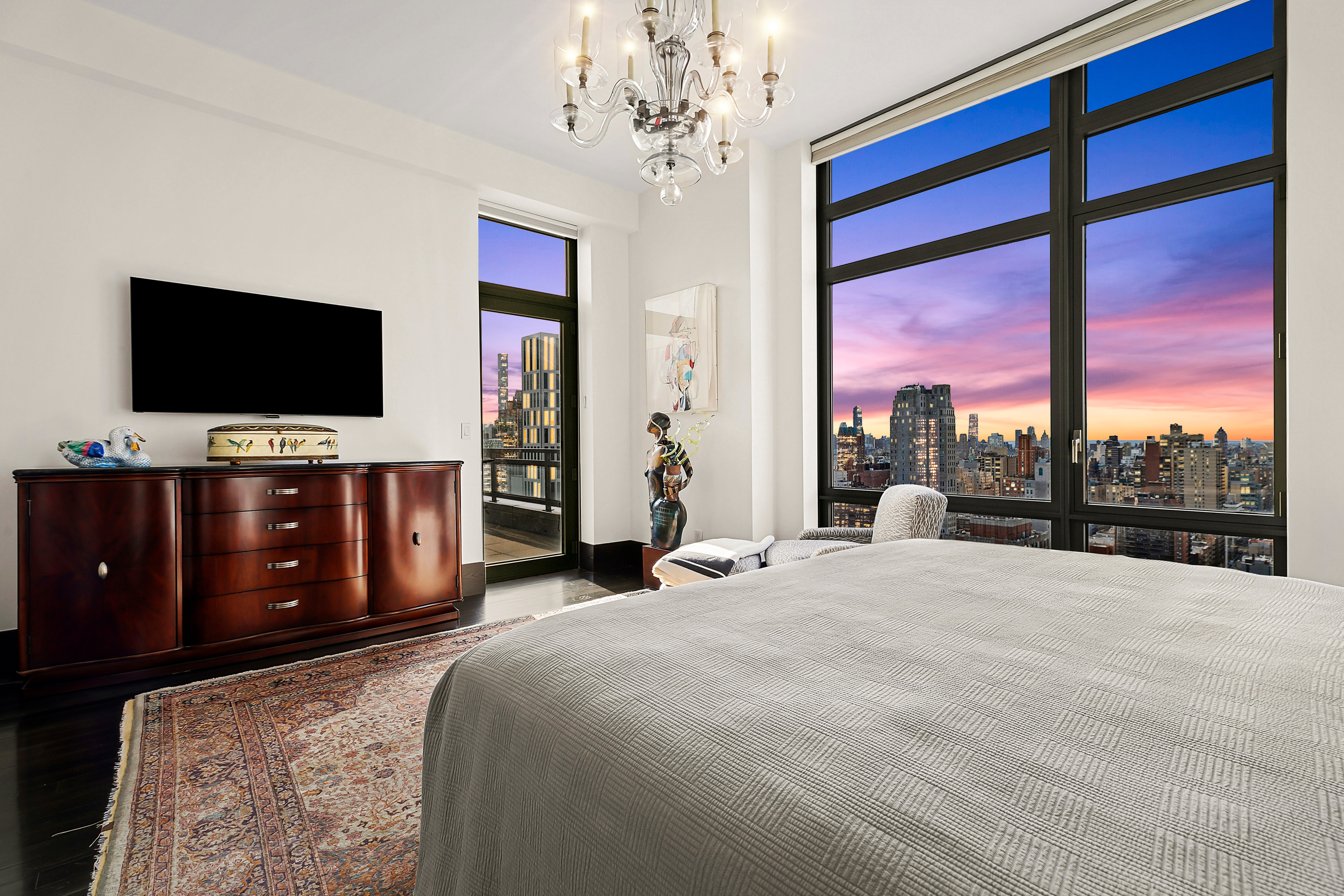 450 East 83rd Street, Unit PH1B Manhattan, NY 10028 - Photo 15 of 15 a spacious bedroom with a large bed and a flat screen tv