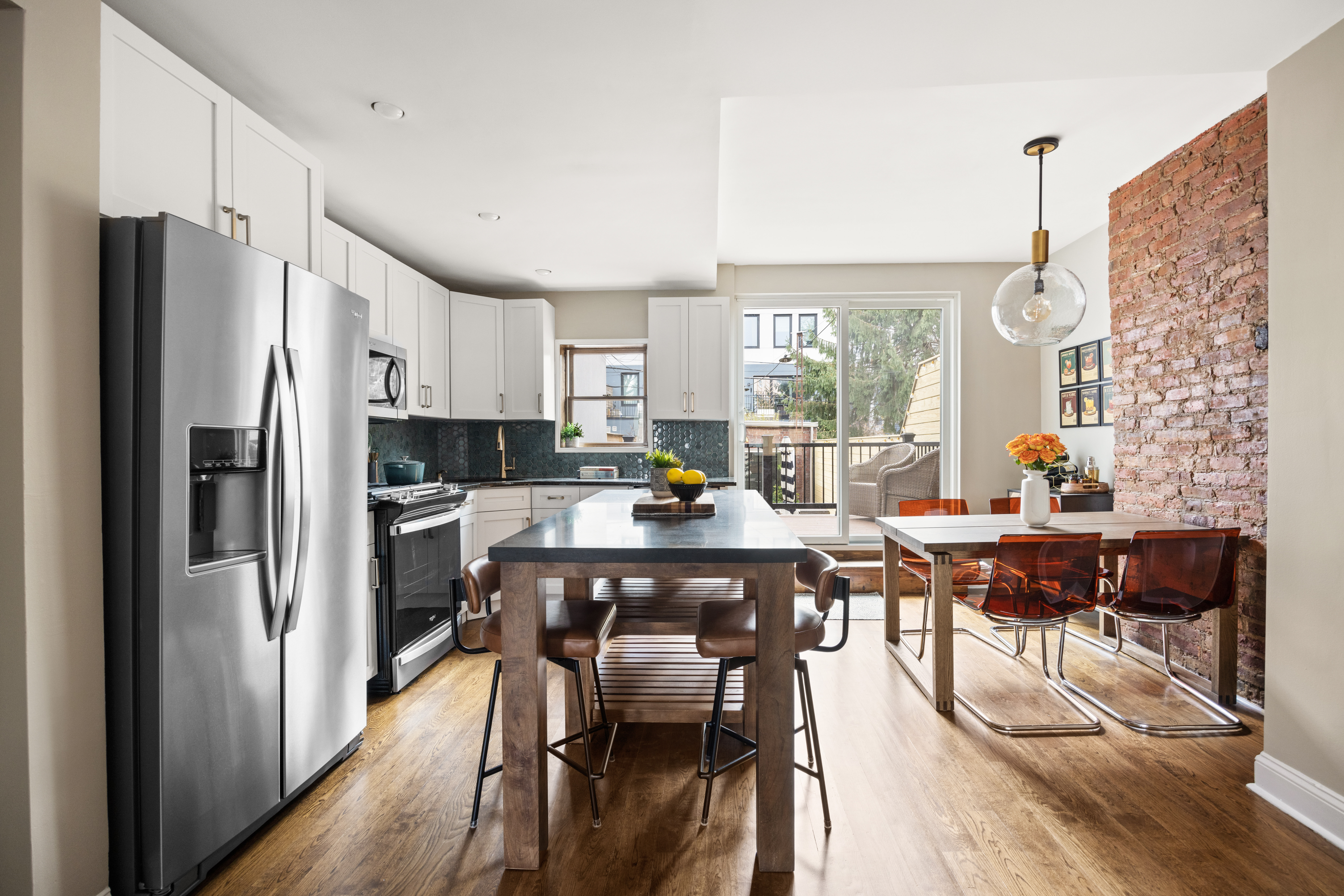 310 A 22nd Street Brooklyn, NY 11215 - Photo 3 of 16 a kitchen with stainless steel appliances a dining table chairs refrigerator and sink