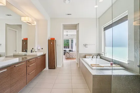 a large spacious bathroom with a granite countertop tub sink and mirror