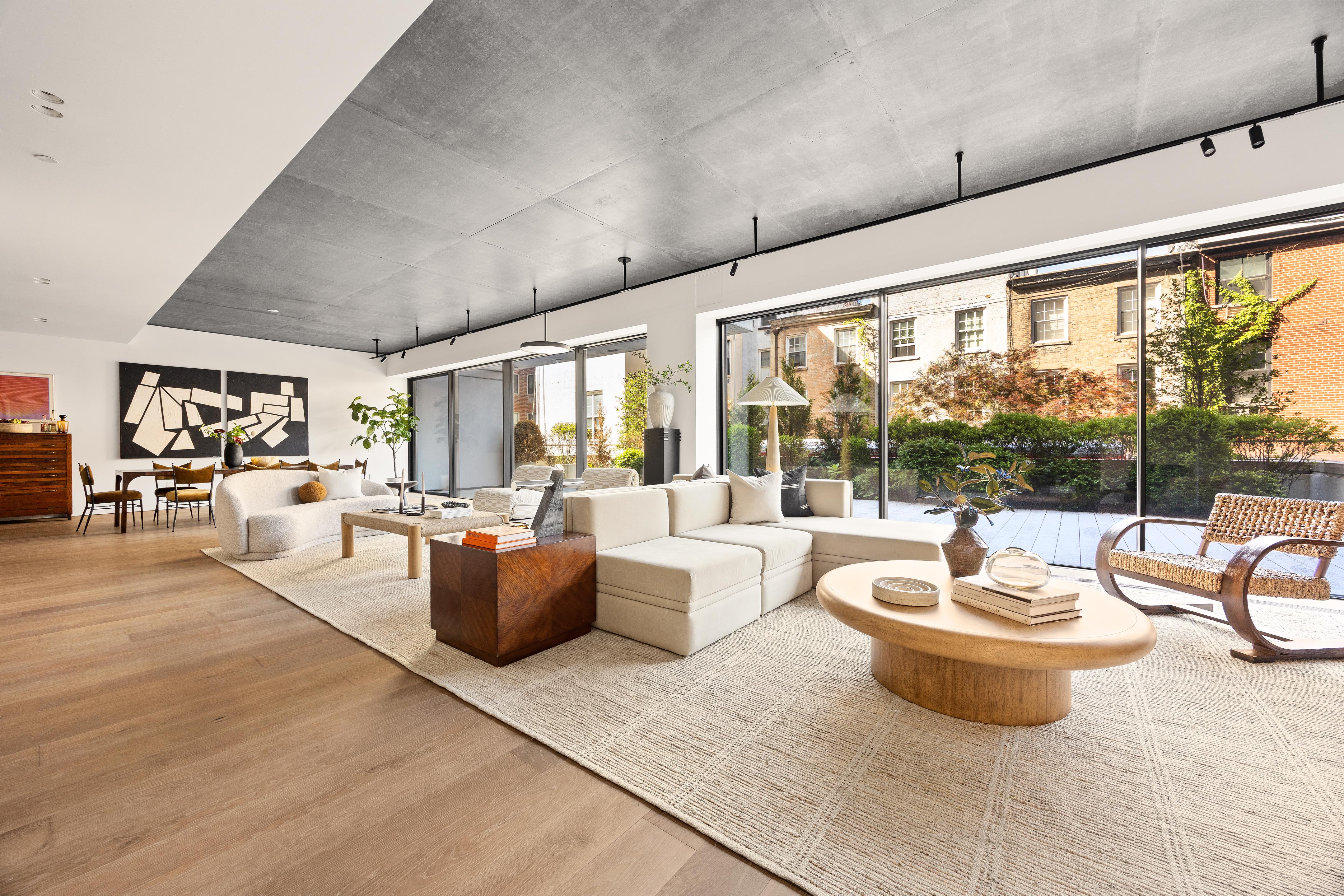 a living room with patio furniture and a potted plant