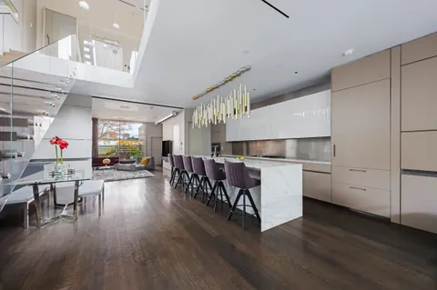a living room with furniture and wooden floors