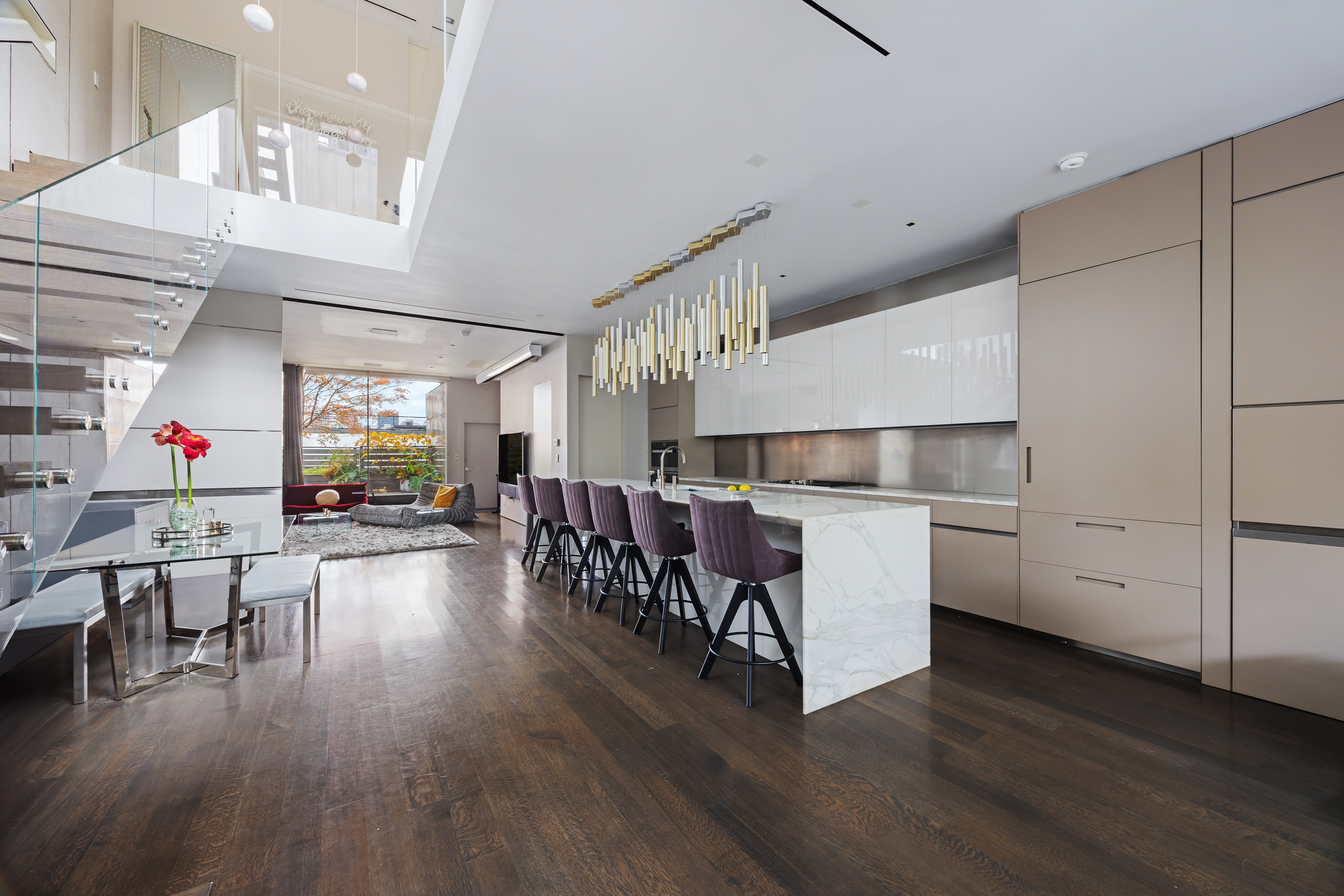 a living room with furniture and wooden floors
