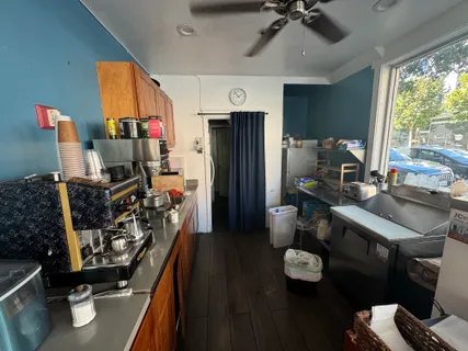 a view of a workspace with furniture and a window