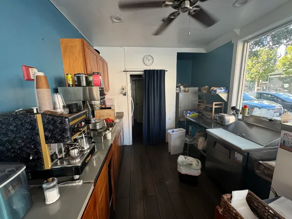 a view of a workspace with furniture and a window