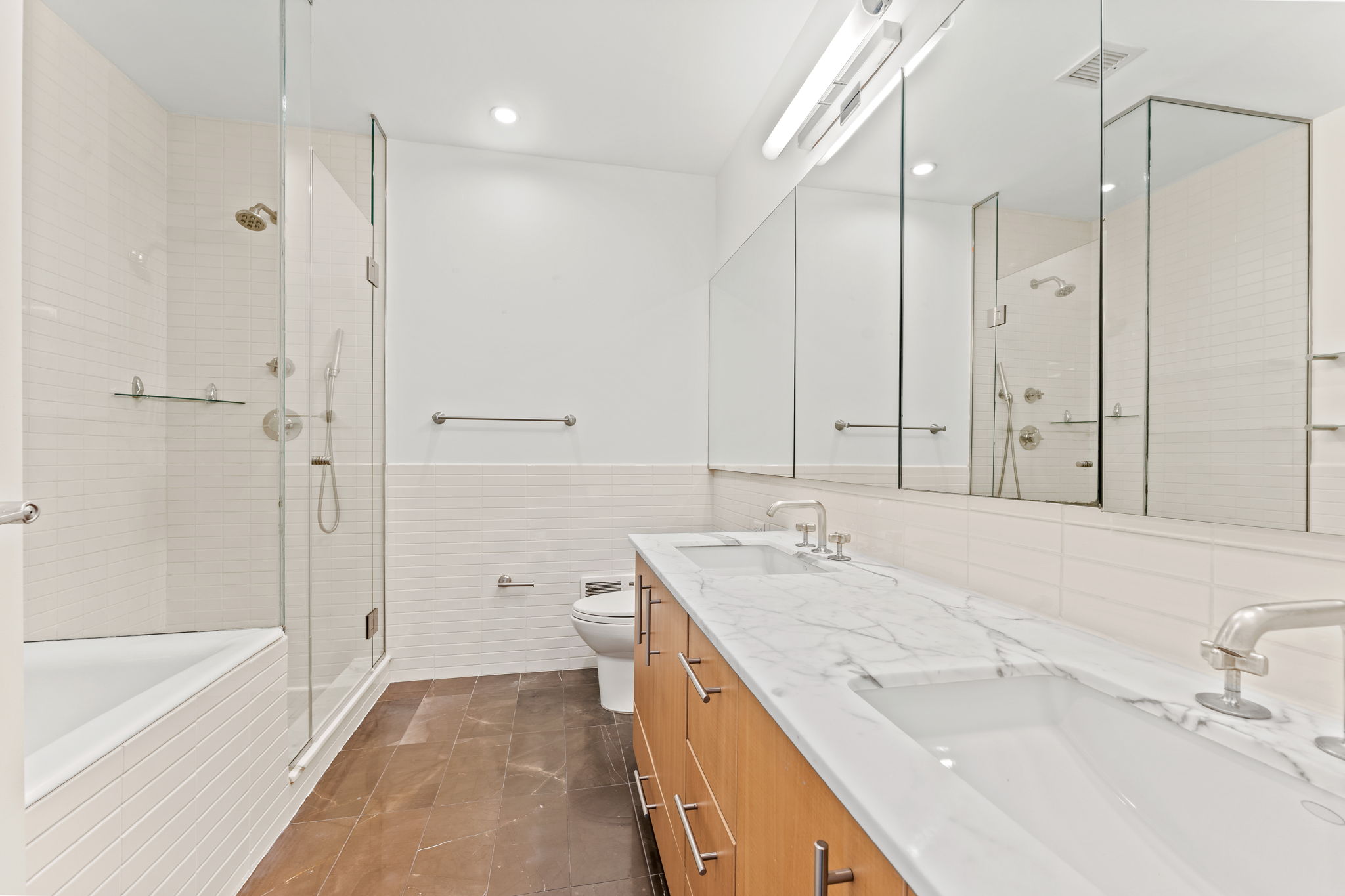 545 West 110th Street, Unit 5A Manhattan, NY 10025 - Photo 19 of 20 a bathroom with a granite countertop sink mirror and a bathtub