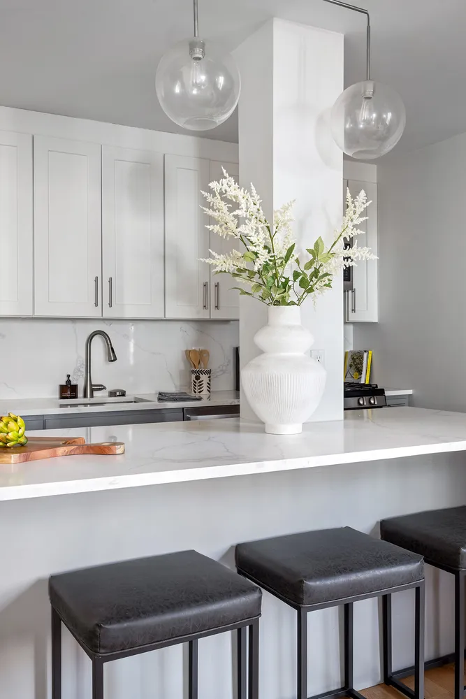 a kitchen with a sink and chandelier