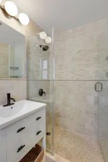 a bathroom with a sink a mirror and shower