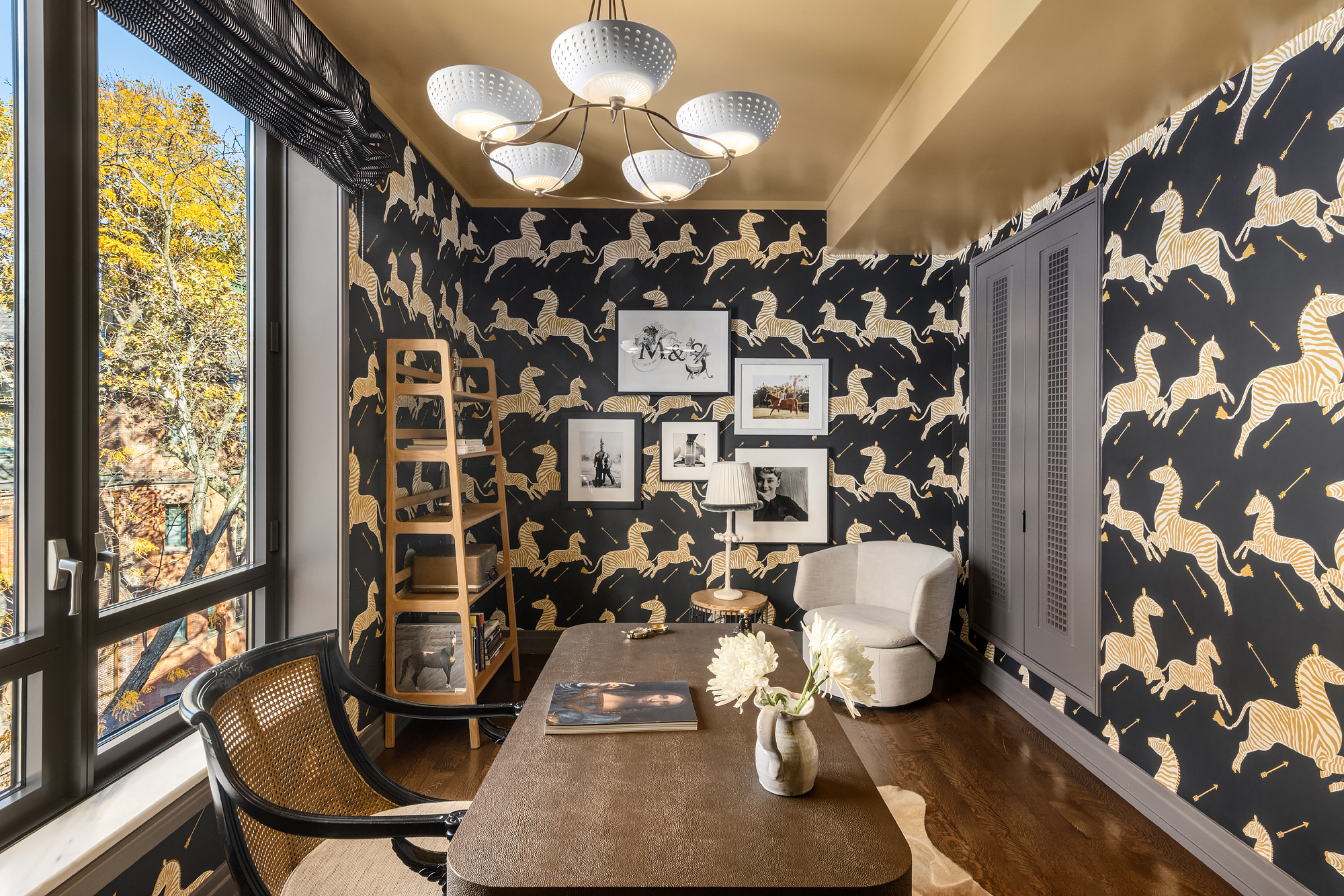 455 West 20th Street, Unit PH Manhattan, NY 10011 - Photo 19 of 21 a view of a workspace with furniture and a floor to ceiling window